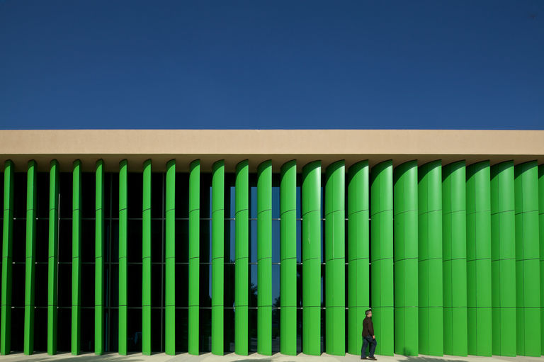 External façade featuring green vertical louvres at Mubarak Bin Mohammed School in Abu Dhabi.