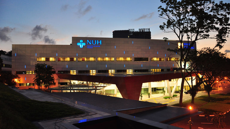 Night shot of the National University Hospital in Singapore where the signage system was designed by Broadway Malyan