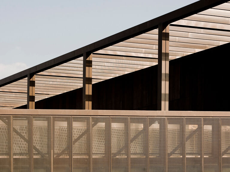 Bronze metal cladding feature of Waitrose in Chester, referencing the industrial heritage of the site.