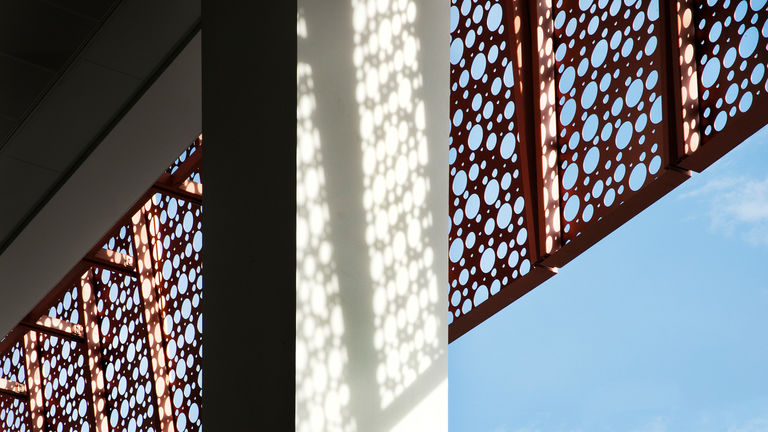 Detail shot of the National Heart Centre, Singapore, featuring a perforated metal cladding
