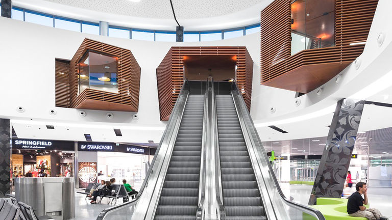 Escalators and high quality interior finishes at newly refurbished and extended Lisbon International Airport, Portugal.
