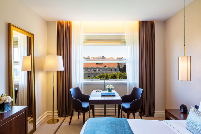 Hotel guest room at Tivoli Avenida Liberdade in Lisbon, refurbished with marble, gold metal, leather and hints of blue.