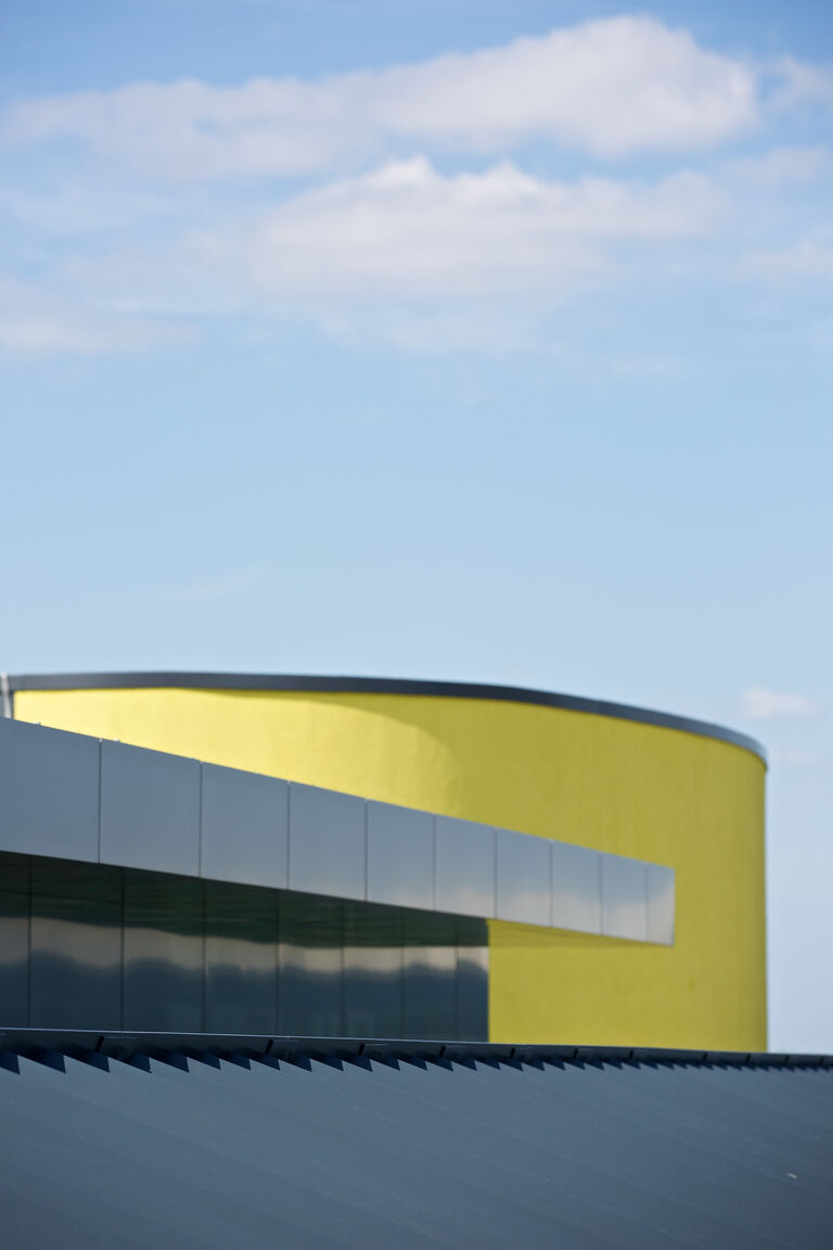 Bright yellow central core at BP's Upstream Learning Centre in Sunbury, housing classrooms, informal spaces and oil extraction simulators.