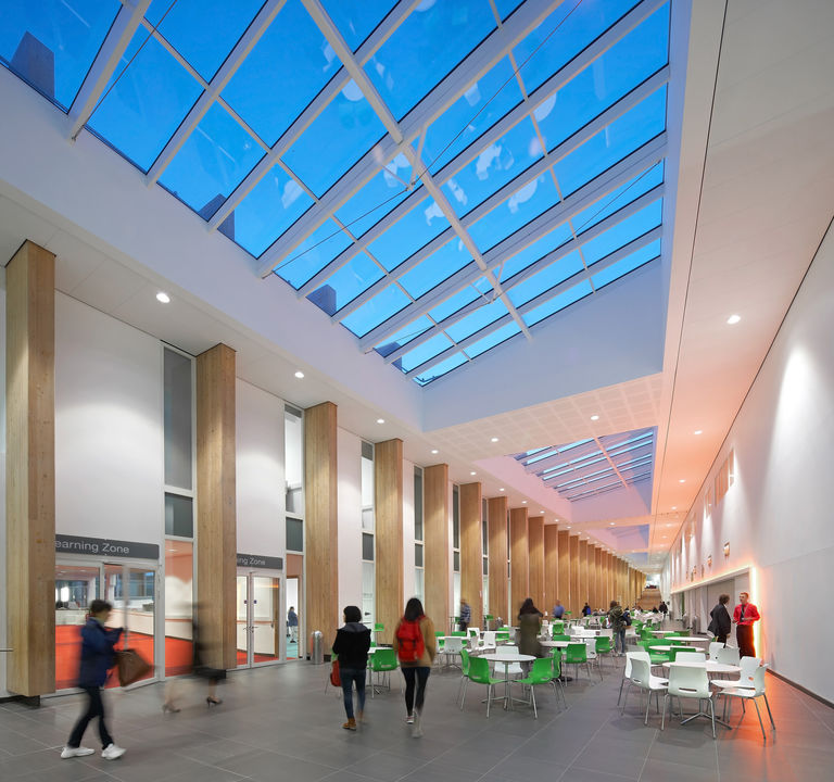 Interior finishes at Bournville College in Birmingham, featuring huge timber frames and glazed ceiling.