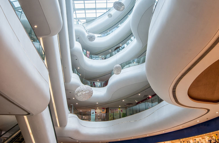 Spectacular circulation bridges at Lefo Mall in Suzhou, China, boasting five floors of natural daylight from the central glass ceiling.
