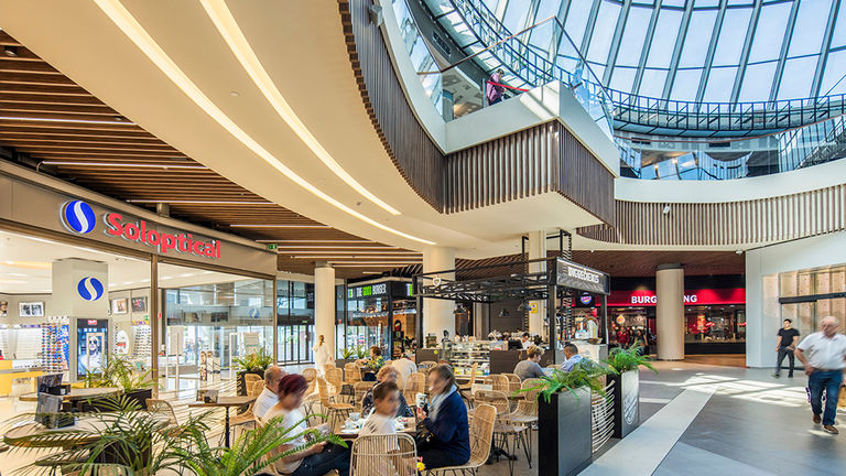 Interior food court with glazed ceiling at INTU Asturias retail and leisure centre in Siero, Spain.
