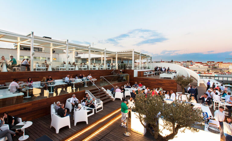 SkyBar, the rooftop hotel terrace at Tivoli Avenida Liberdade, with curved staircase, back lit bar and views over Lisbon.