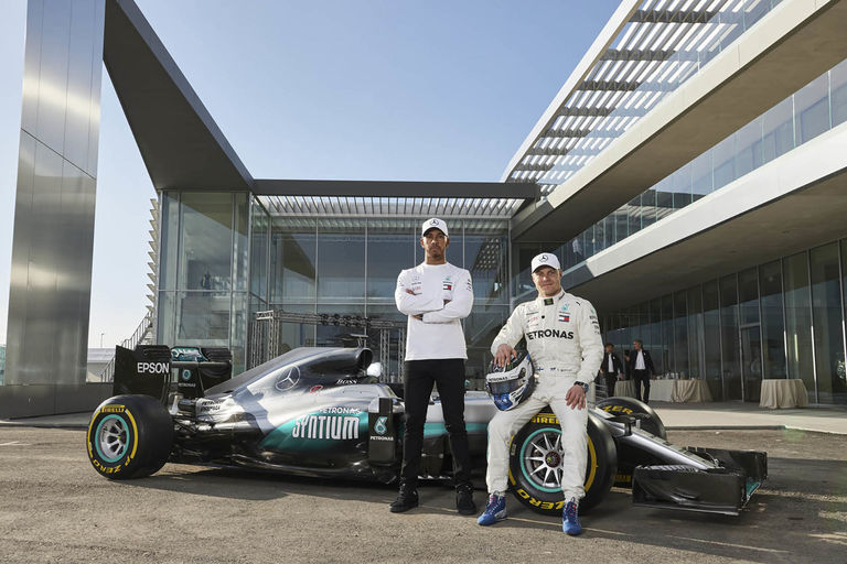 Lewis Hamilton and Valtteri Bottas from the McLaren F1 team in front of Petronas' European R&D centre in Turin, Italy, designed by Broadway Malyan